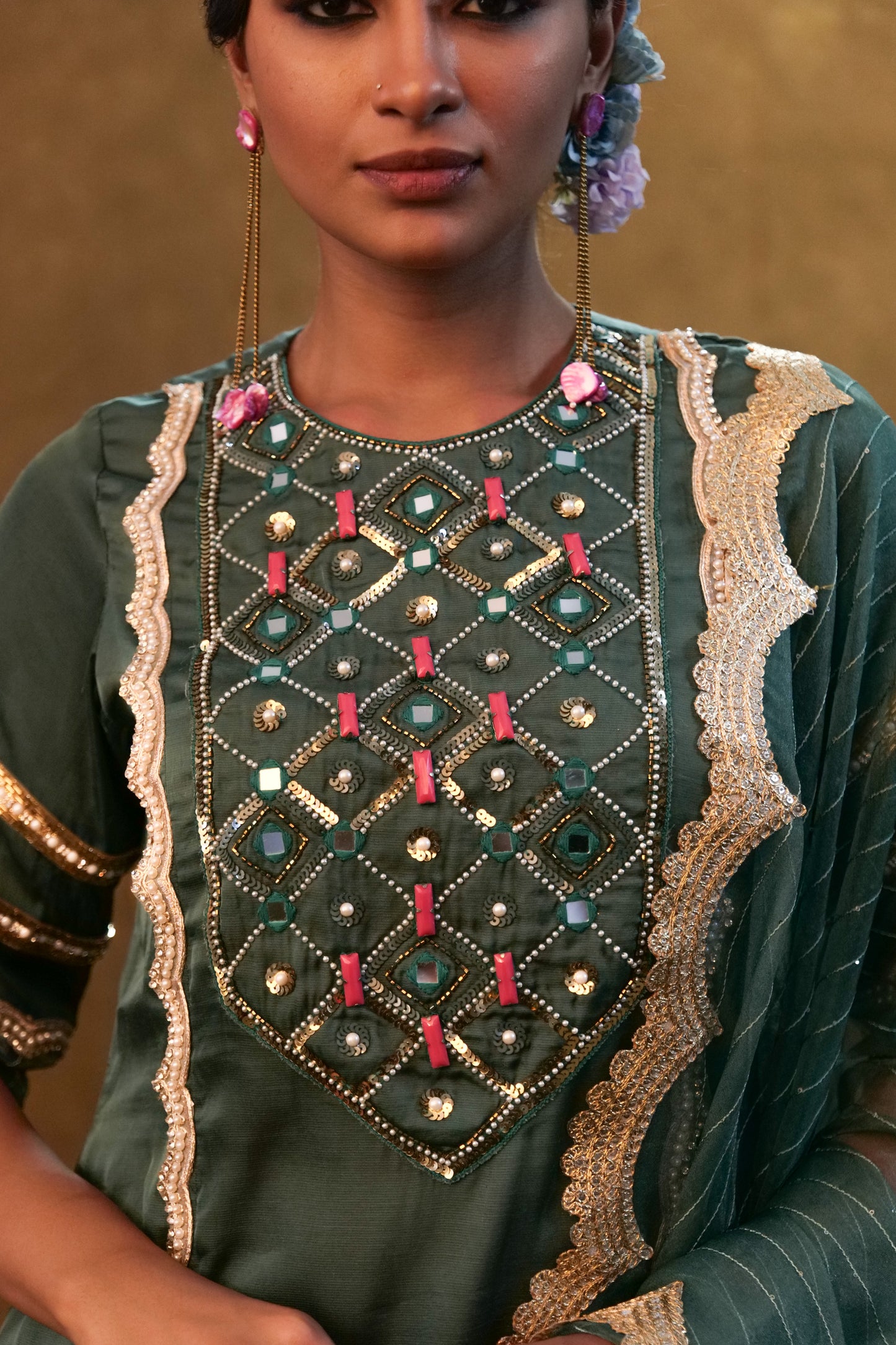 Emerald green kurta set paired with pants and organza dupatta