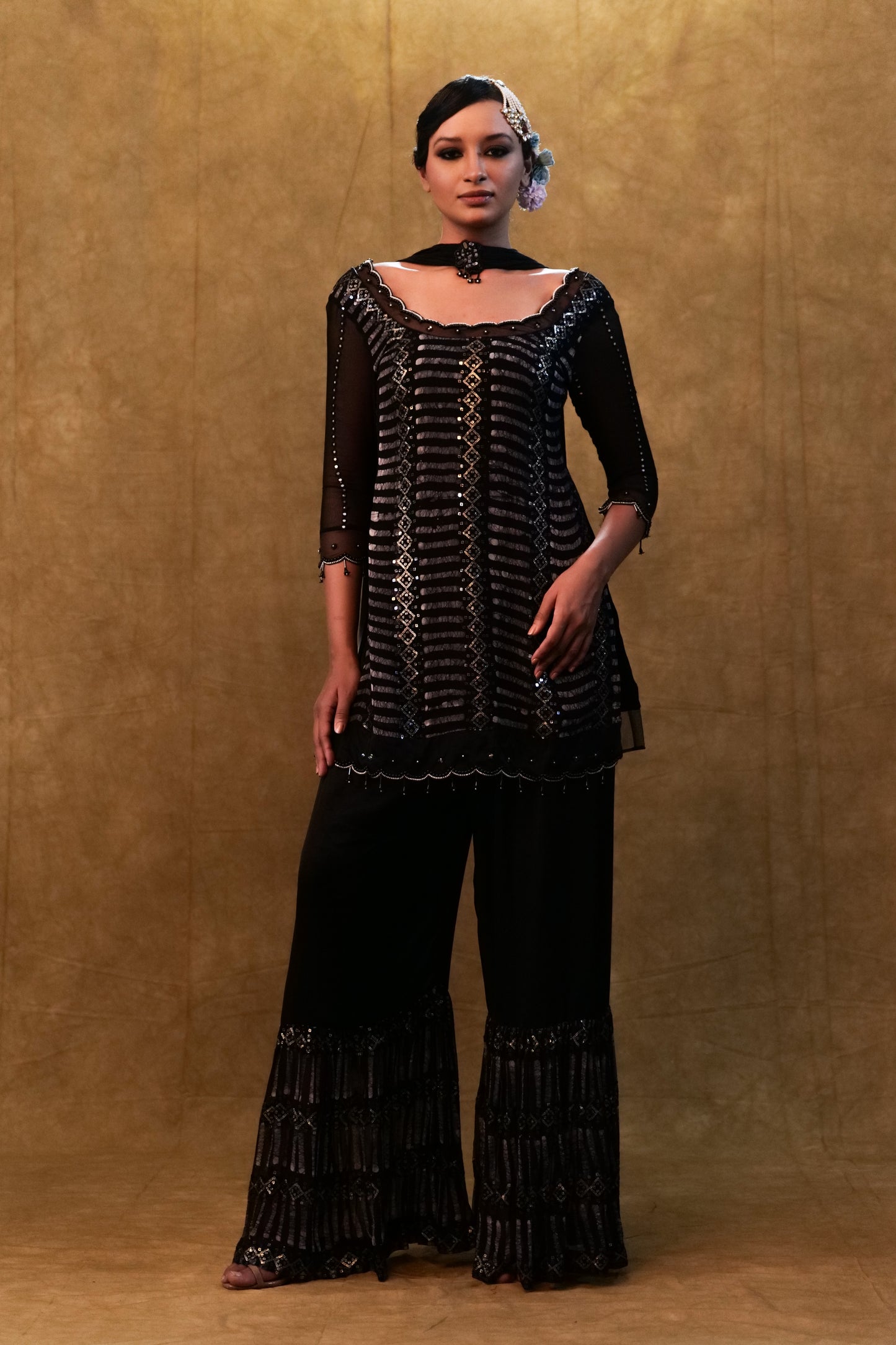 Black kurta set paired with fringe dupatta and flared pants