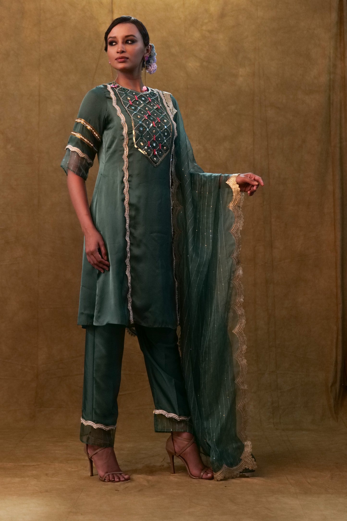 Emerald green kurta set paired with pants and organza dupatta