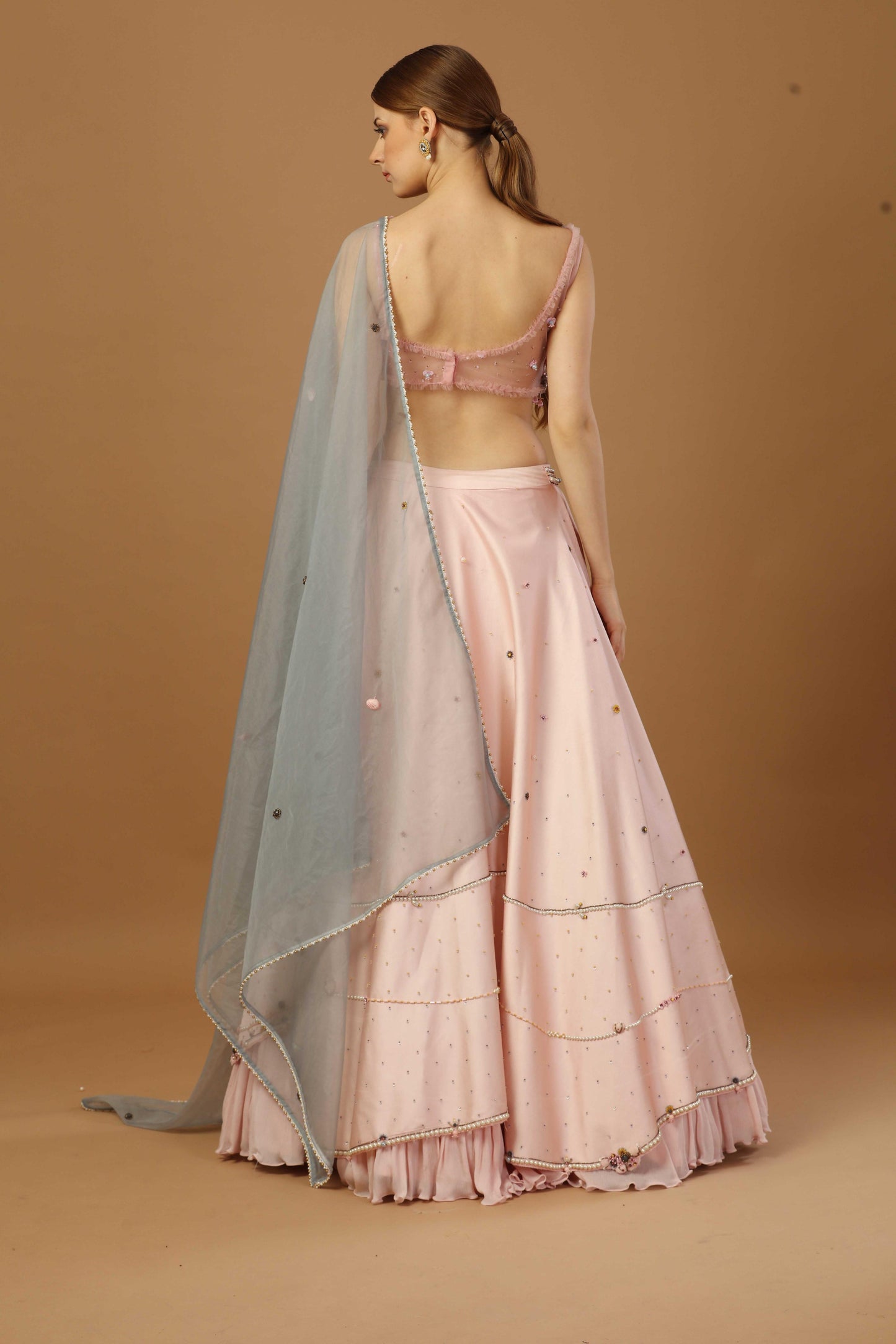 Assymetric Lehenga with strap blouse and a organza dupatta.