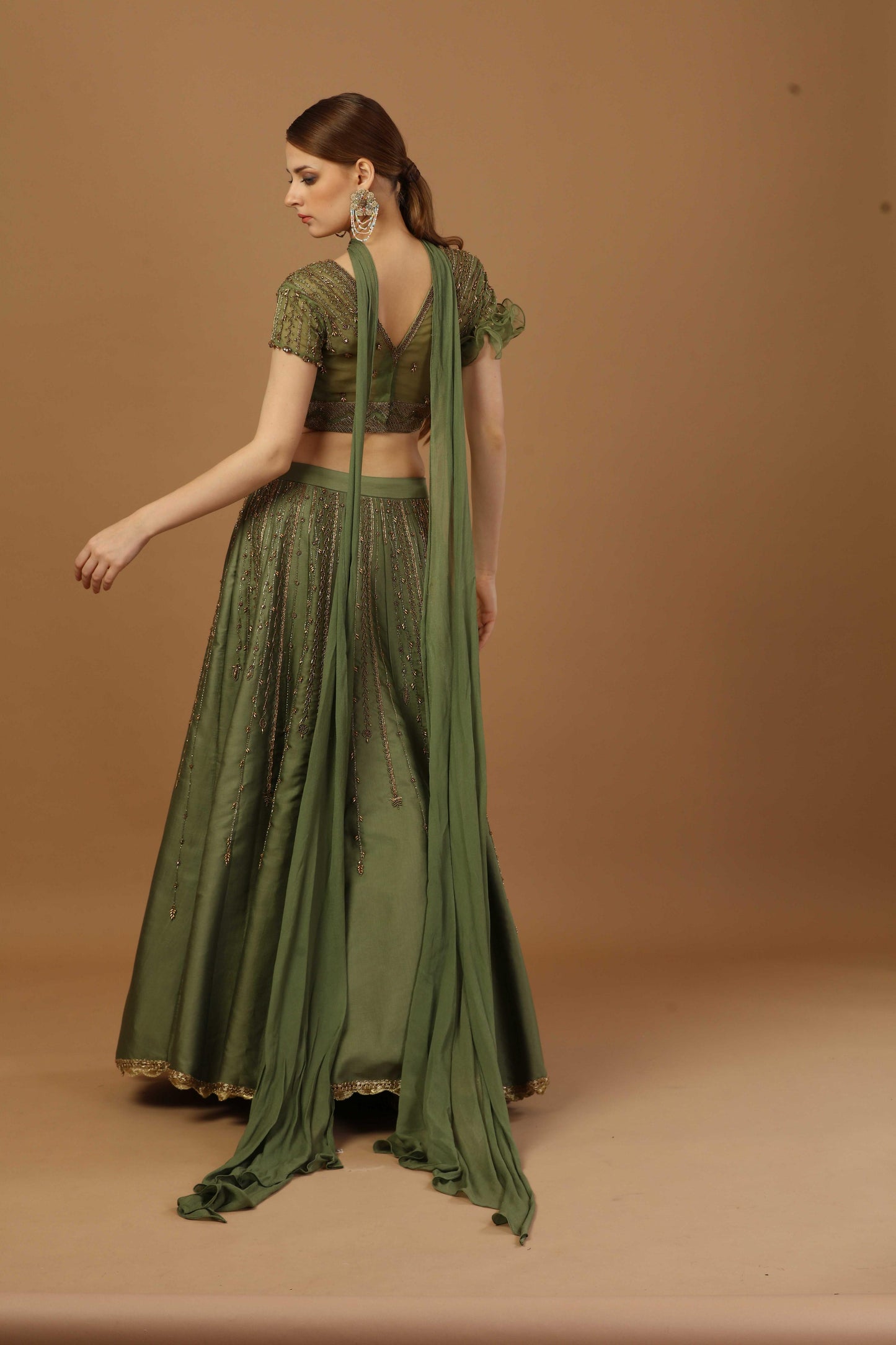 Blouse with one sided ruffle sleeve ,comes with lehenga and a narrow neck dupatta