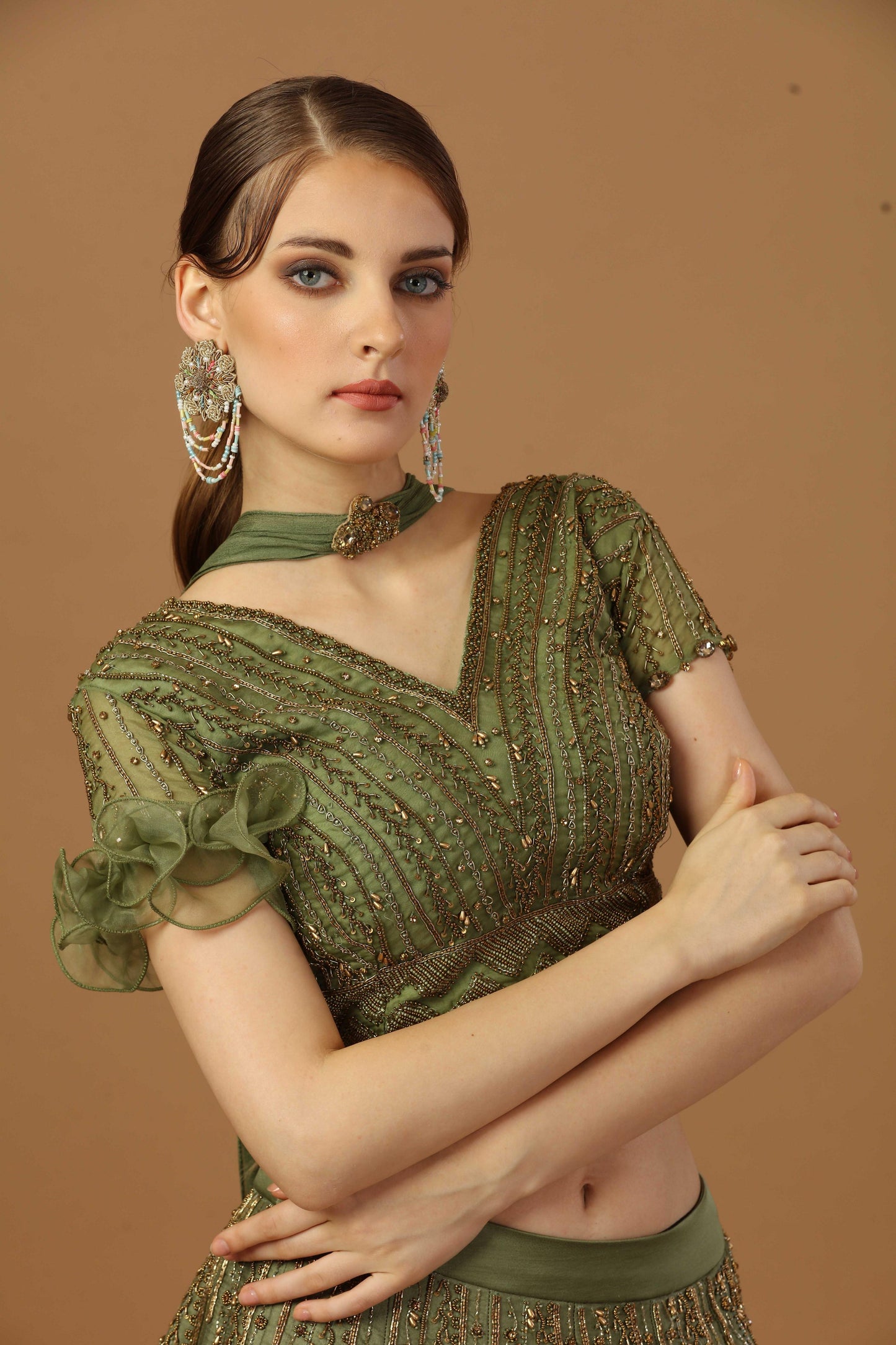 Blouse with one sided ruffle sleeve ,comes with lehenga and a narrow neck dupatta