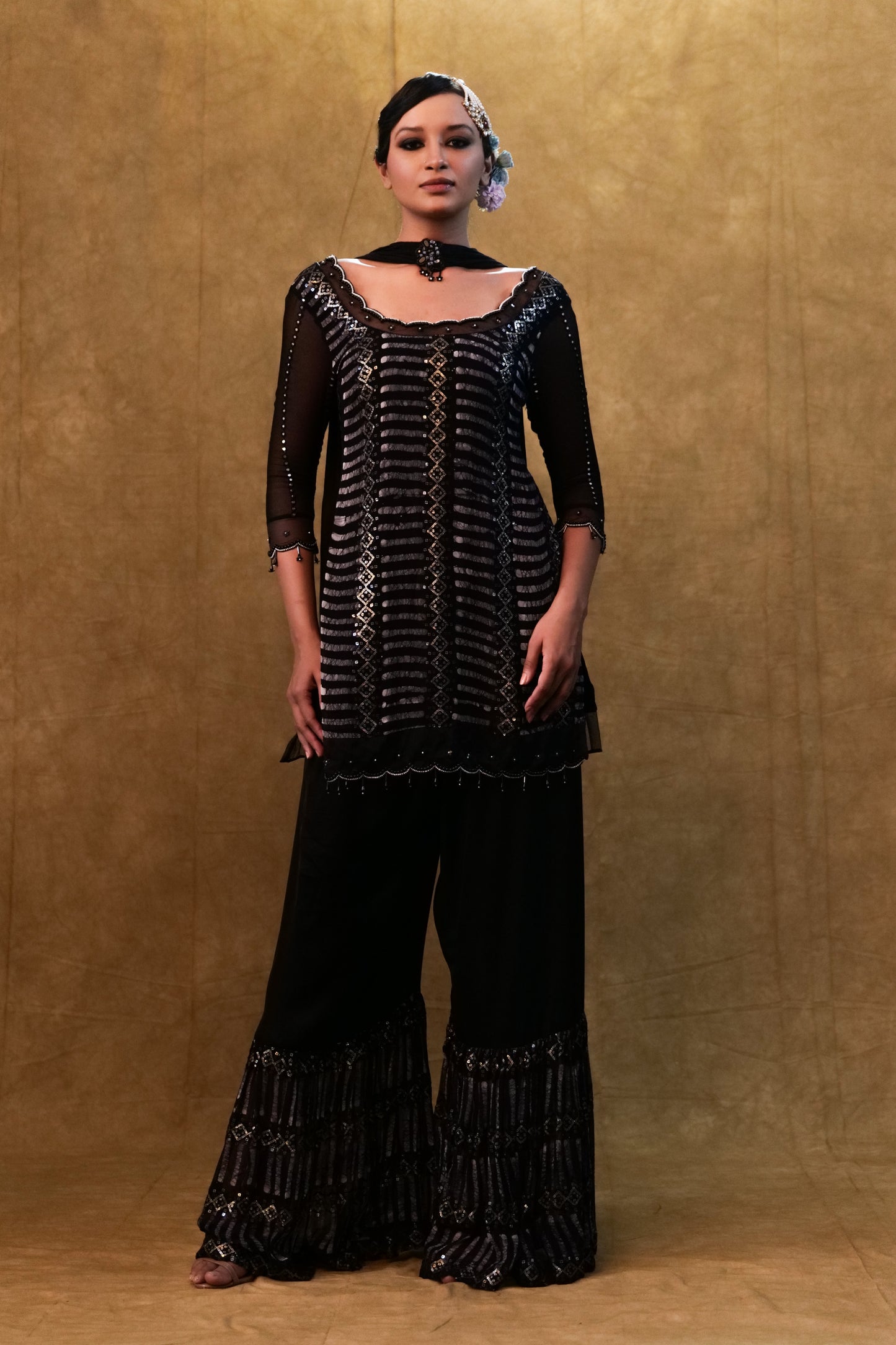 Black kurta set paired with fringe dupatta and flared pants