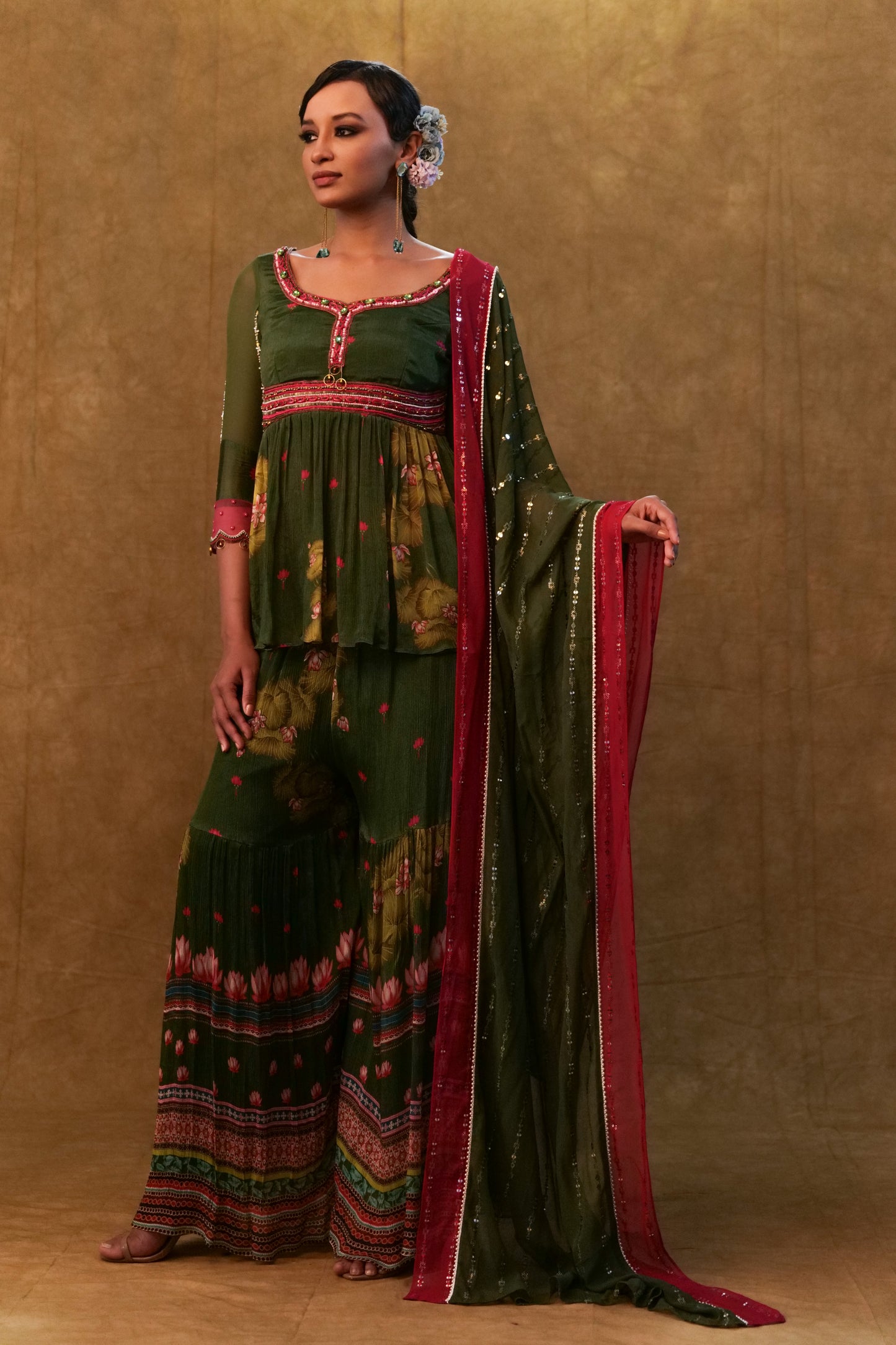 Green printed sharara set paired with color block dupatta and a peplum