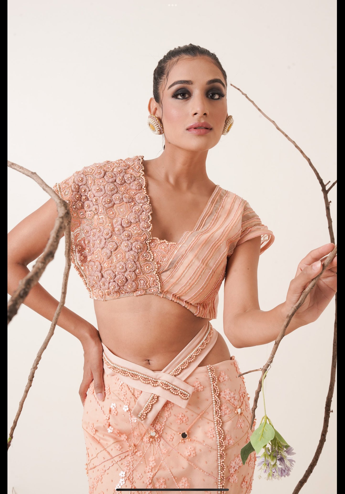 Peach fish cut lehenga with asymmetrical blouse look.