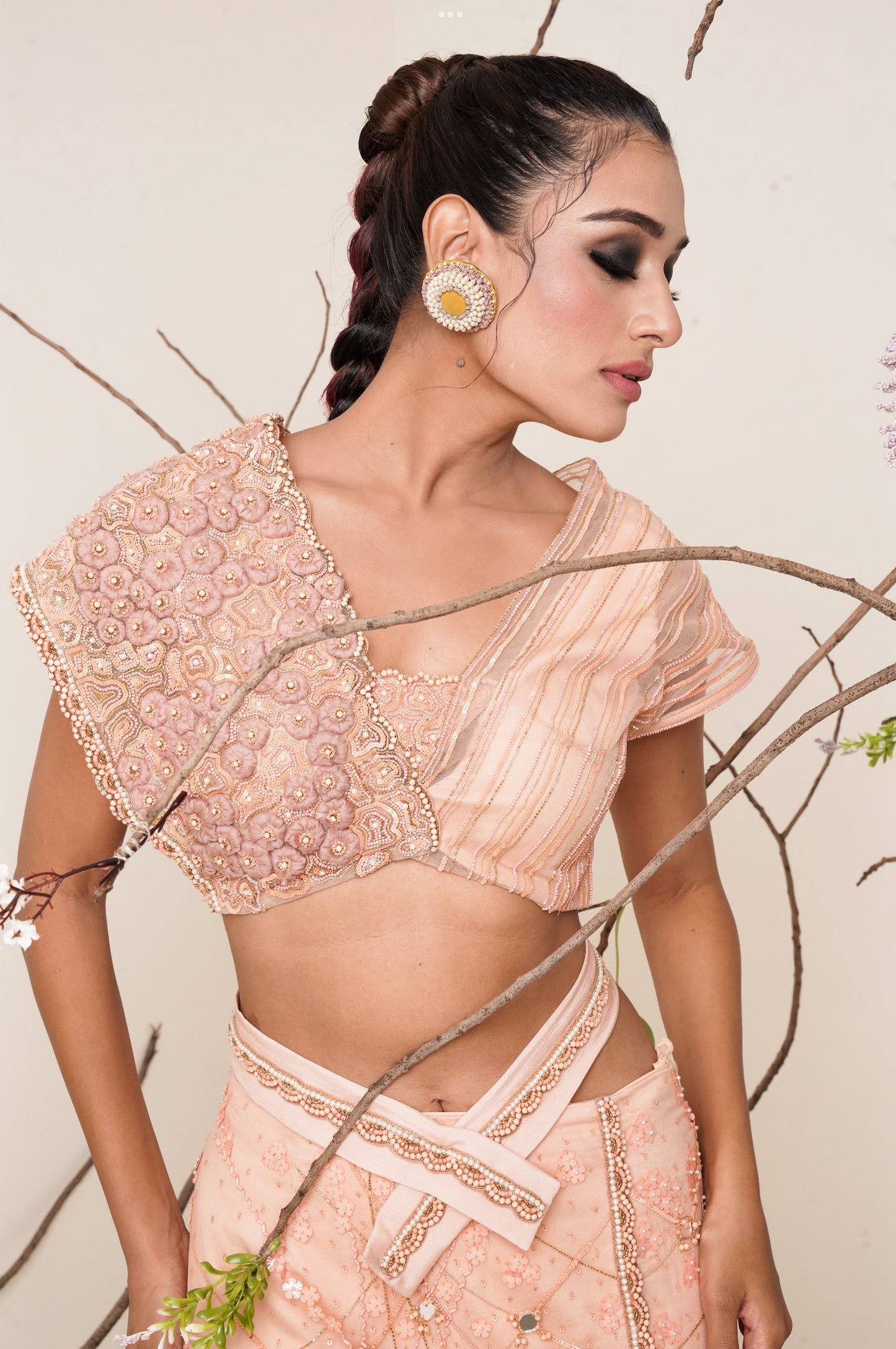 Peach fish cut lehenga with asymmetrical blouse look.