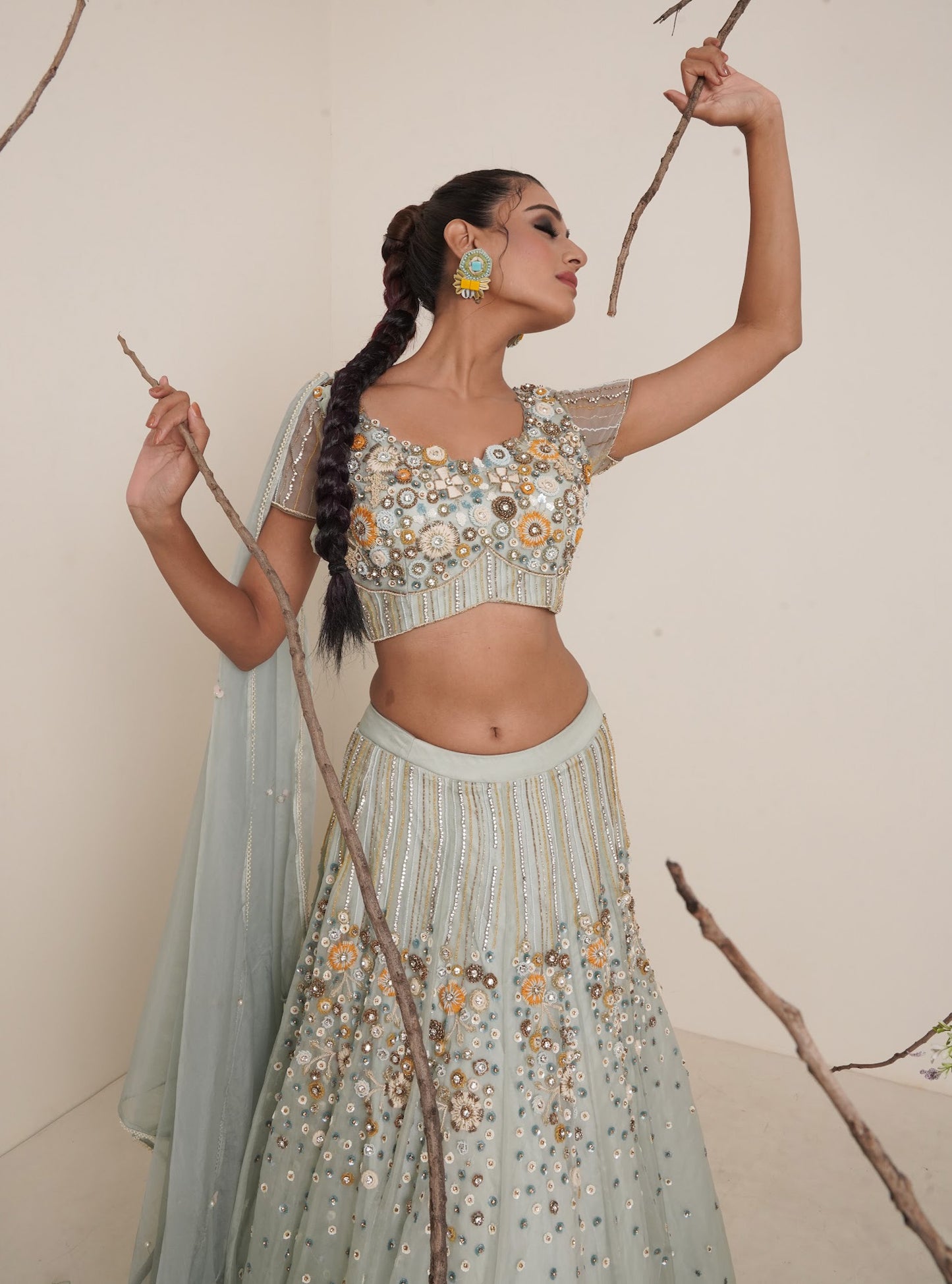 Aqua lehenga adorned in multi colour embroidery.