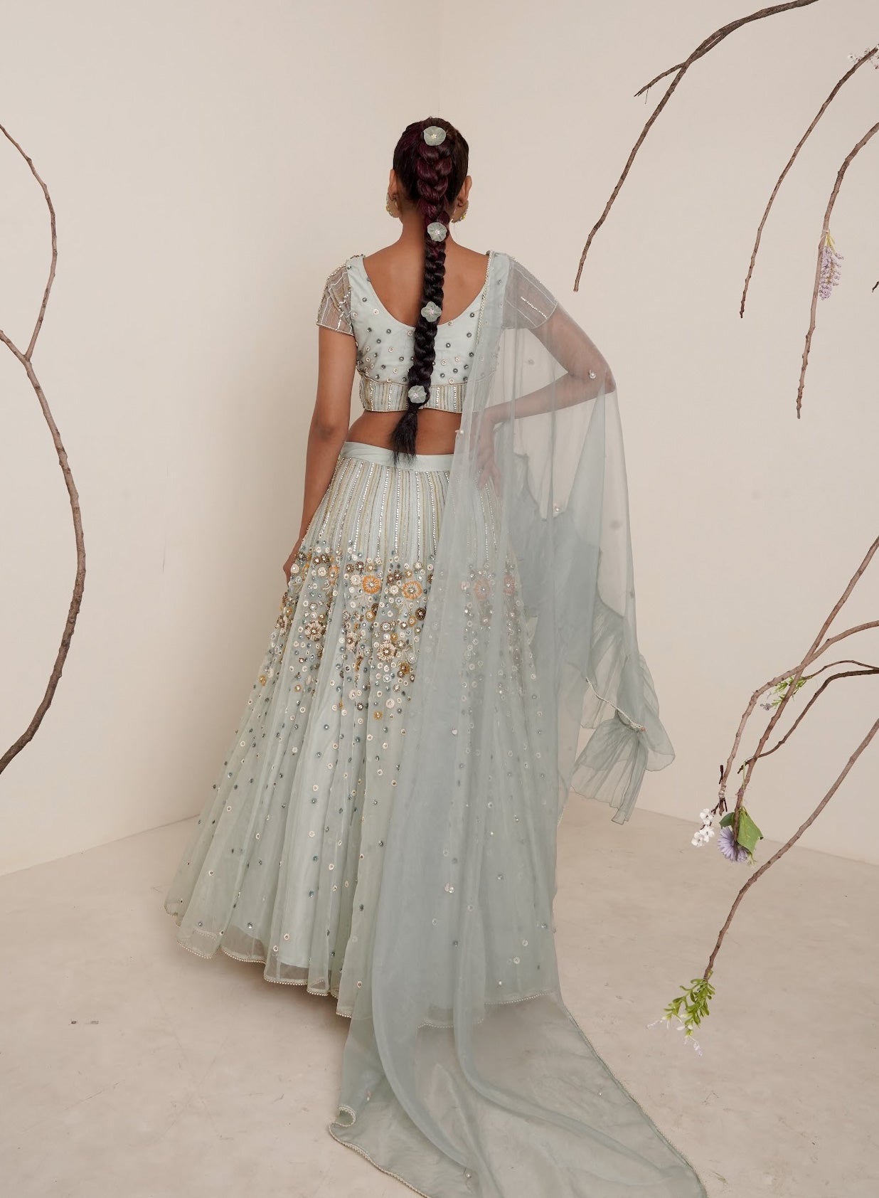 Aqua lehenga adorned in multi colour embroidery.