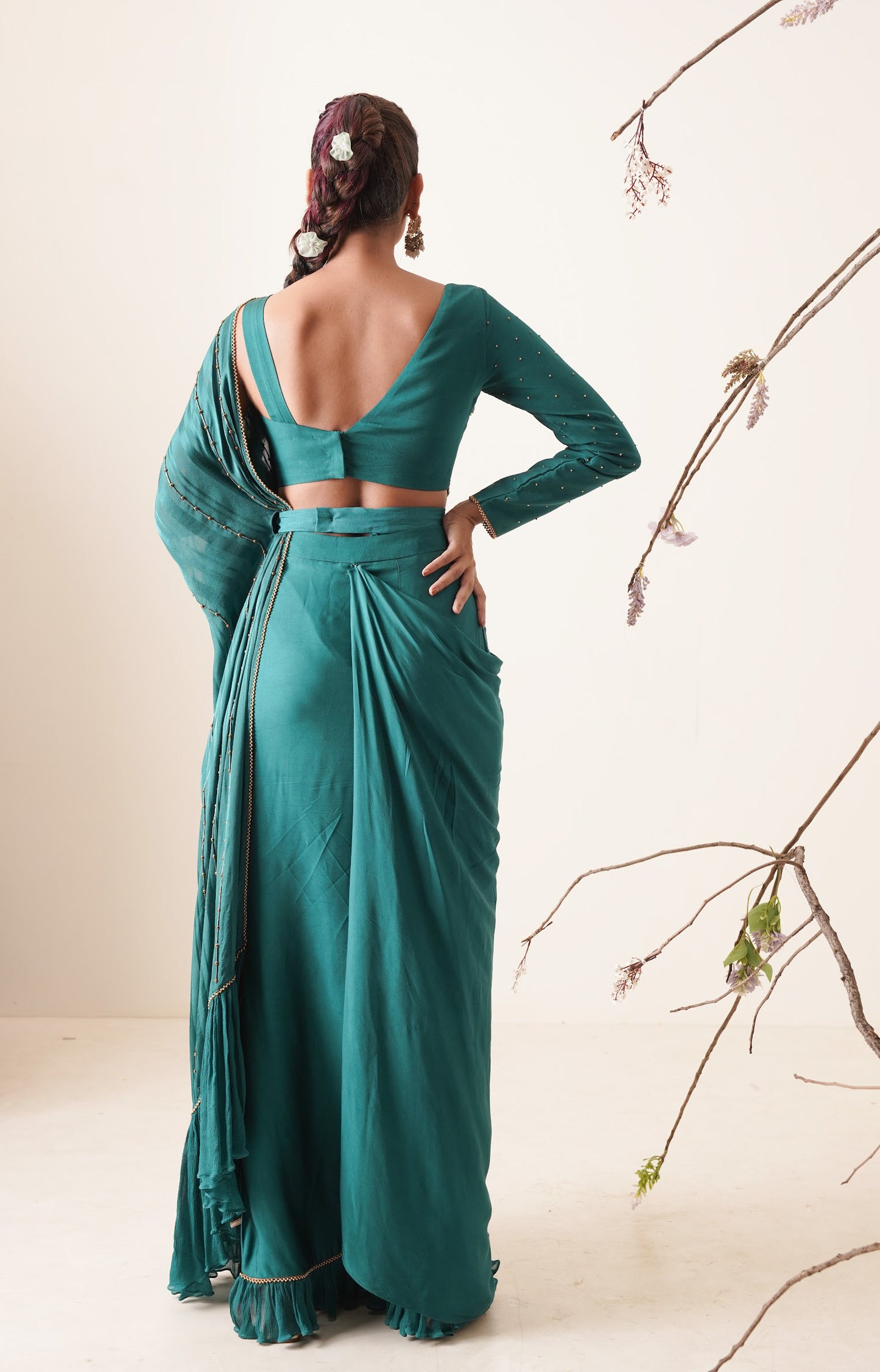 teal color pre-drape saree with waist belt and pallu comes in a full sleeve style.