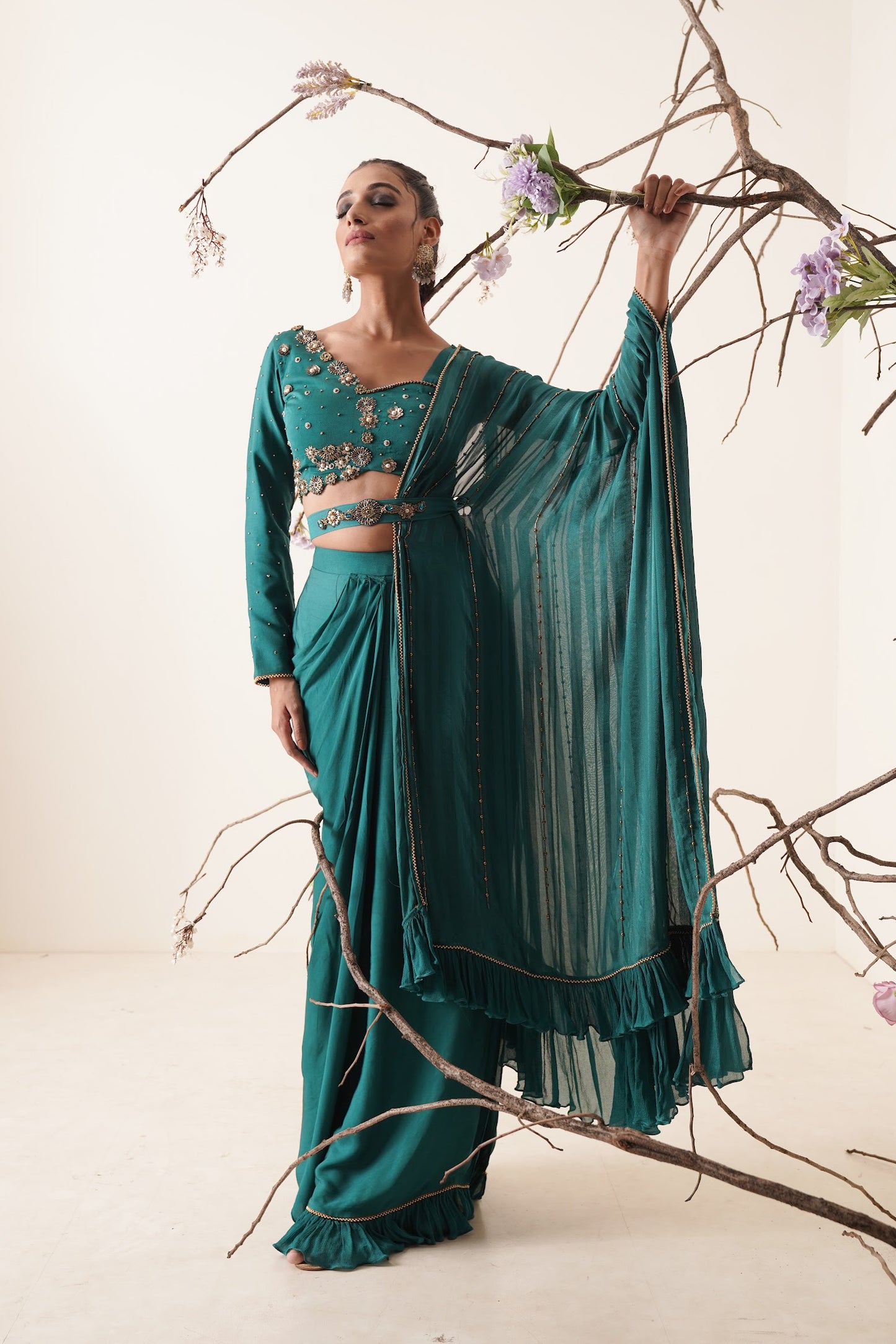 teal color pre-drape saree with waist belt and pallu comes in a full sleeve style.