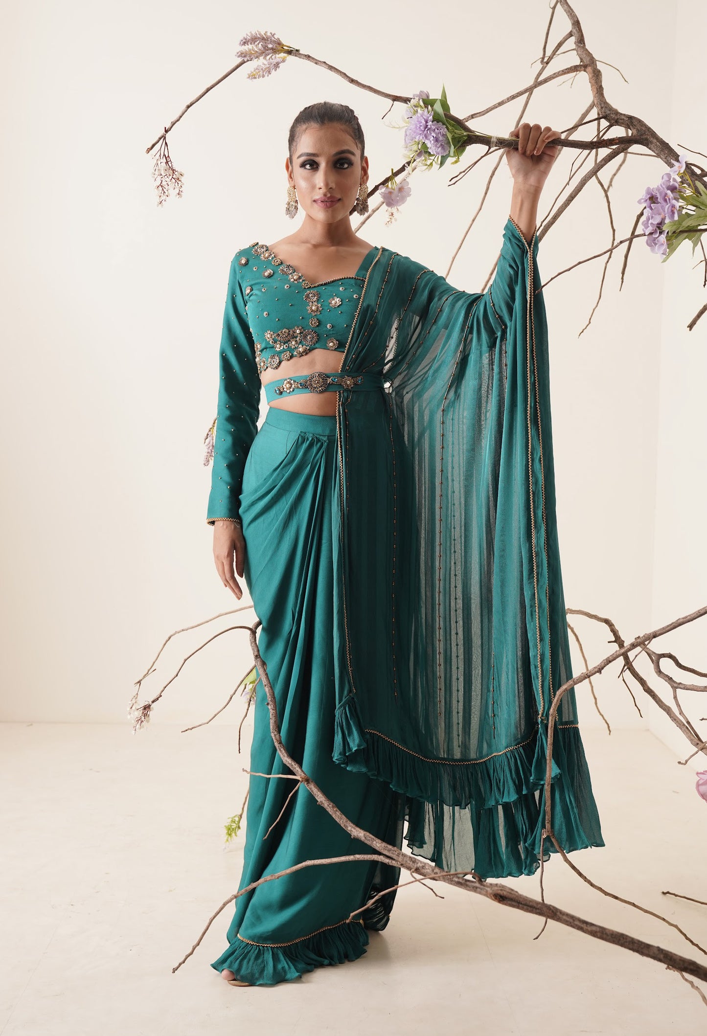 teal color pre-drape saree with waist belt and pallu comes in a full sleeve style.