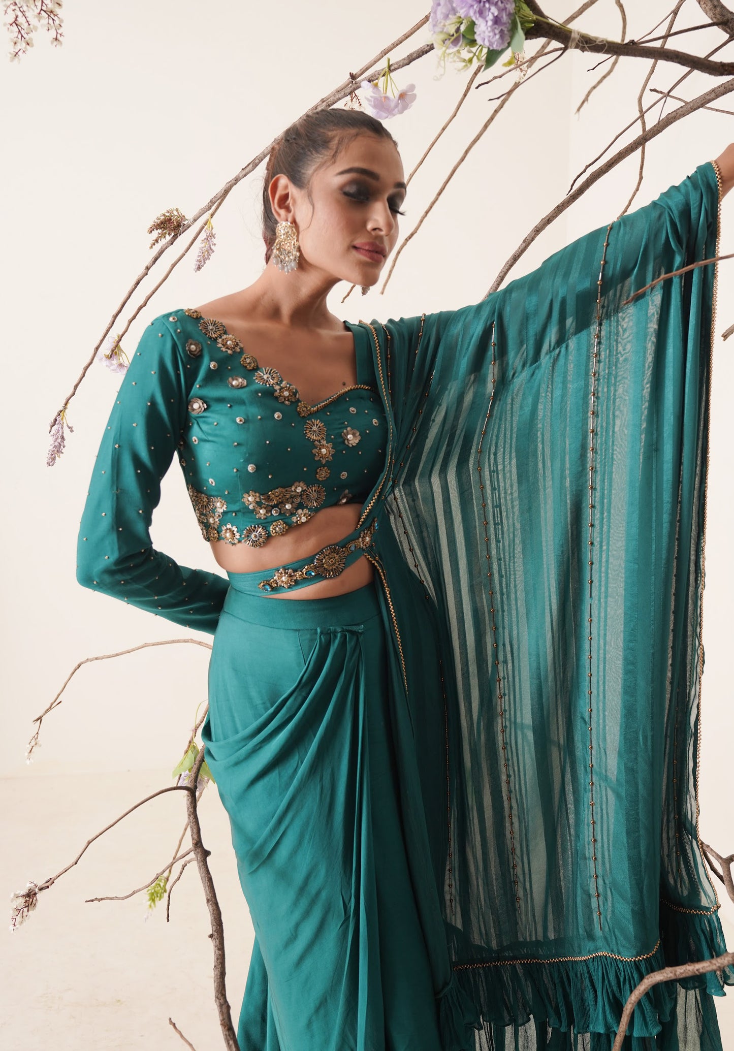 teal color pre-drape saree with waist belt and pallu comes in a full sleeve style.
