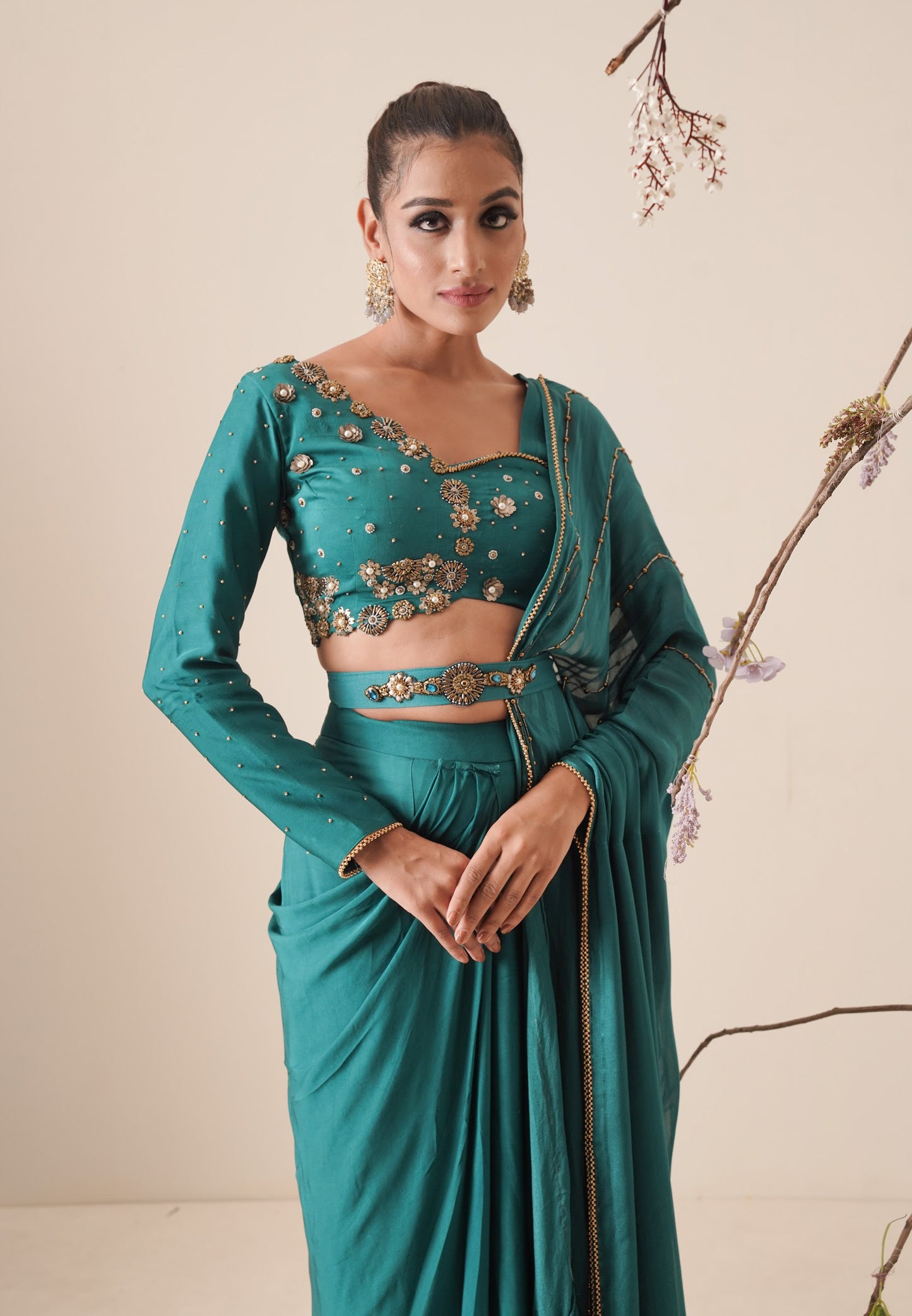 teal color pre-drape saree with waist belt and pallu comes in a full sleeve style.